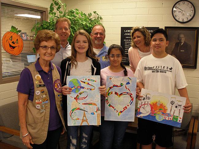  Ivy Tucker, second from left, with her winning poster. To her left are third and second place finis
