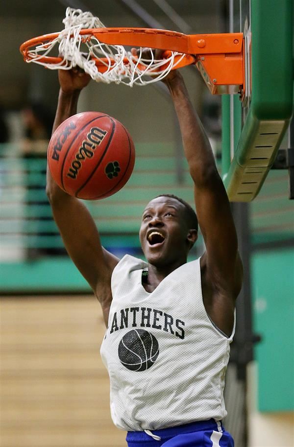 Amphi High basketball player Jackson Ruai dunks a basketball