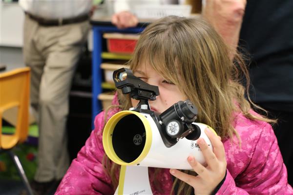  Little girls looking through telescope