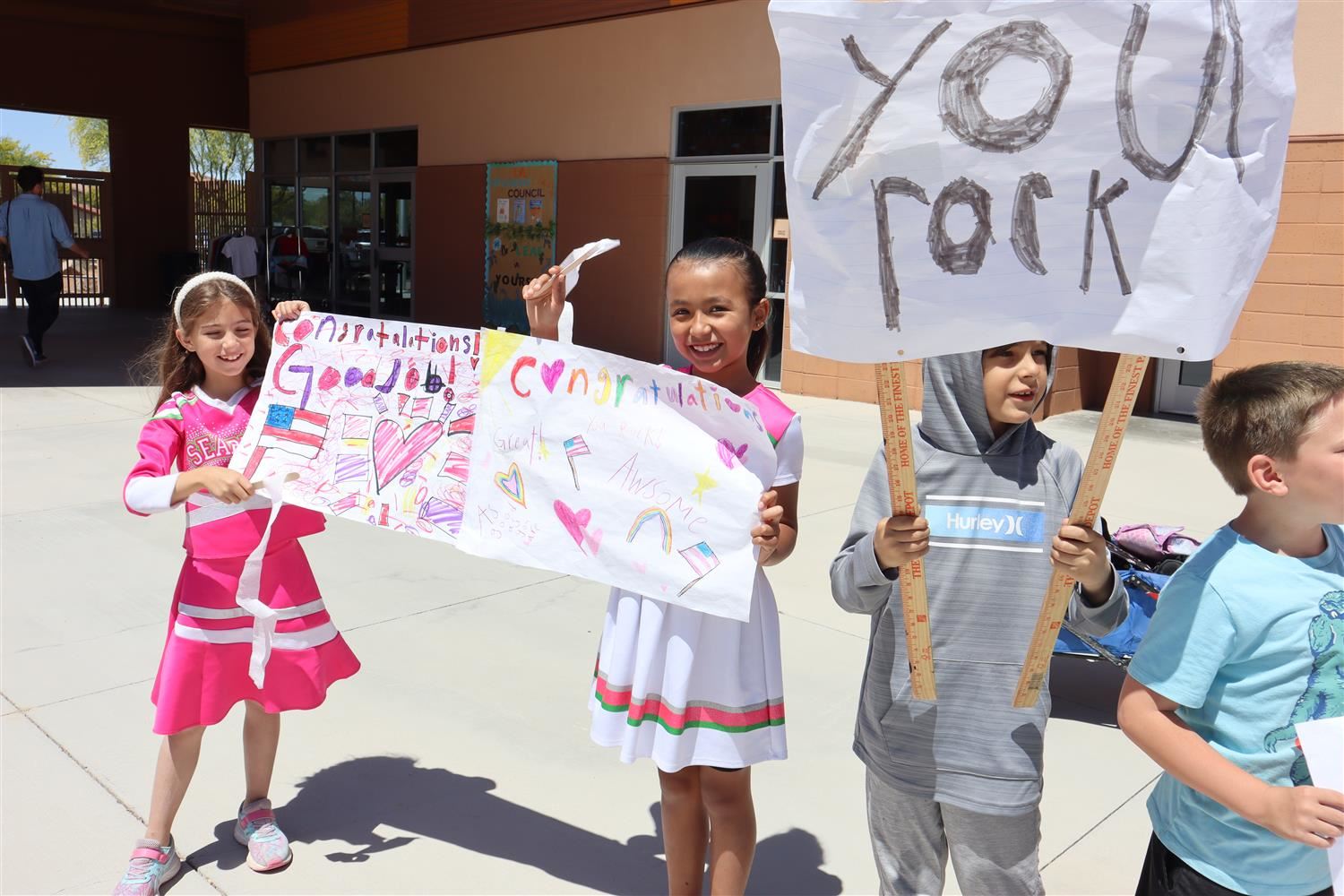  Innovation Academy students with congrats signs